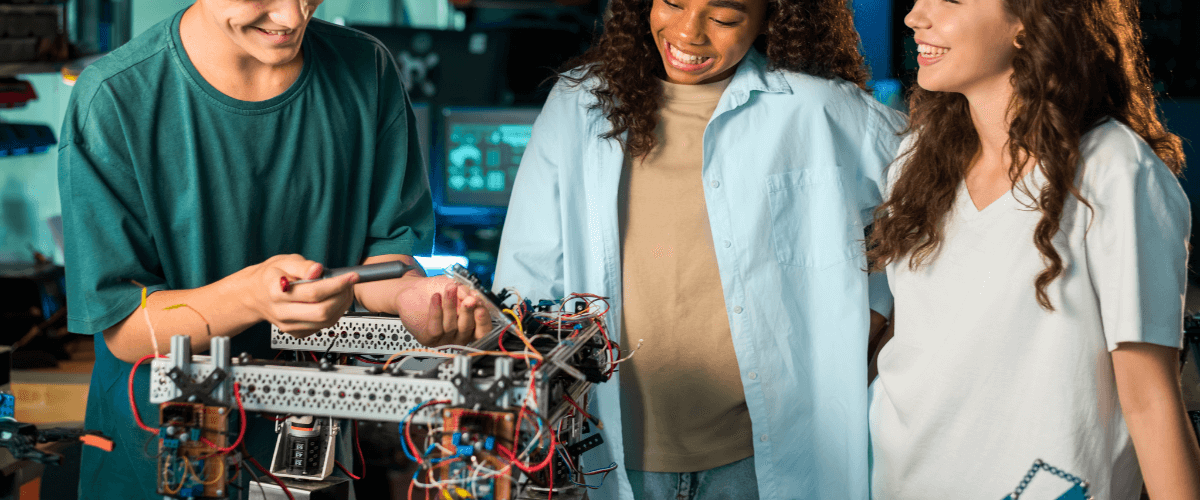 Group of high school students collaborating on a robotics project in a STEM-focused classroom.