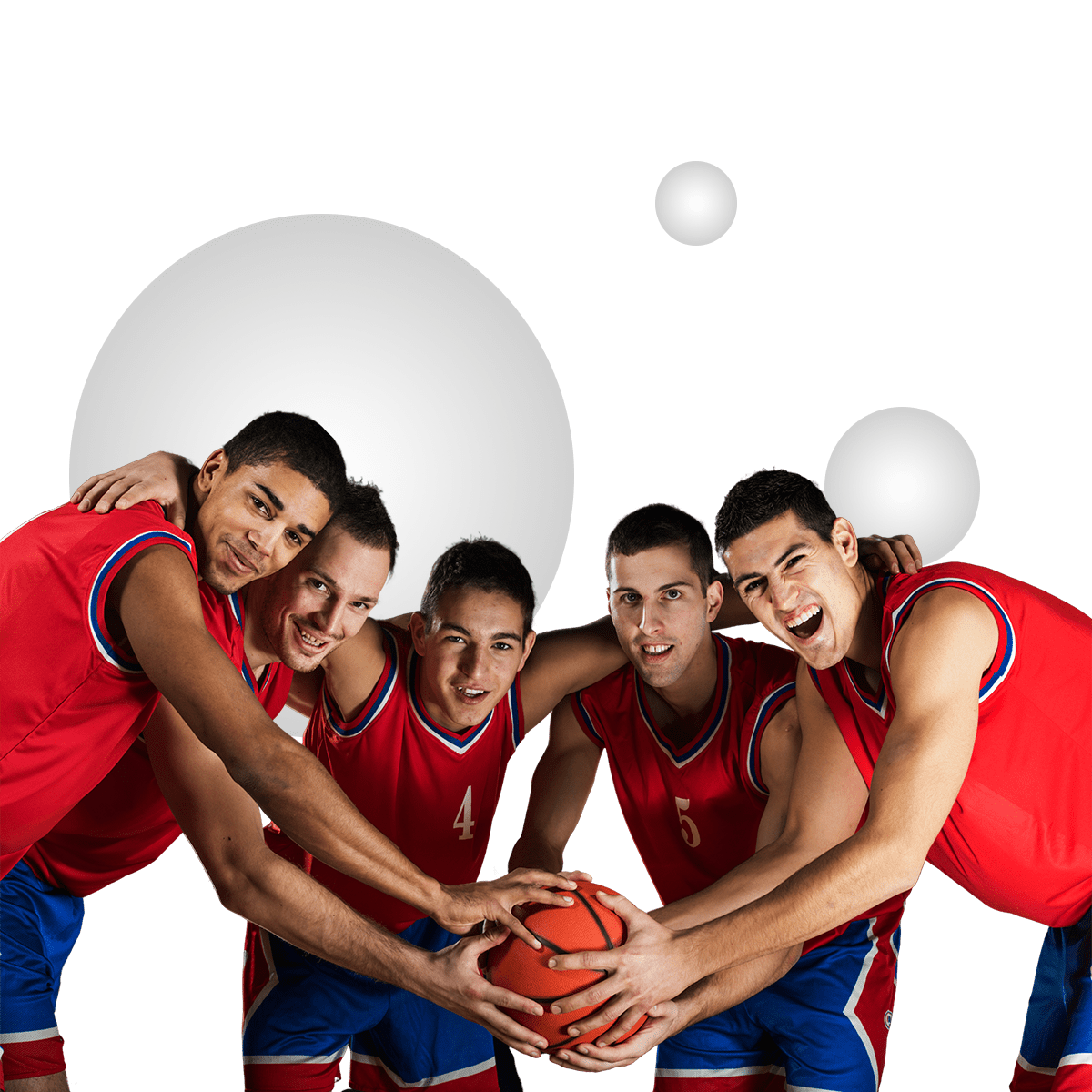 A group of five basketball players in red jerseys huddle together, smiling and holding a basketball with their hands united.