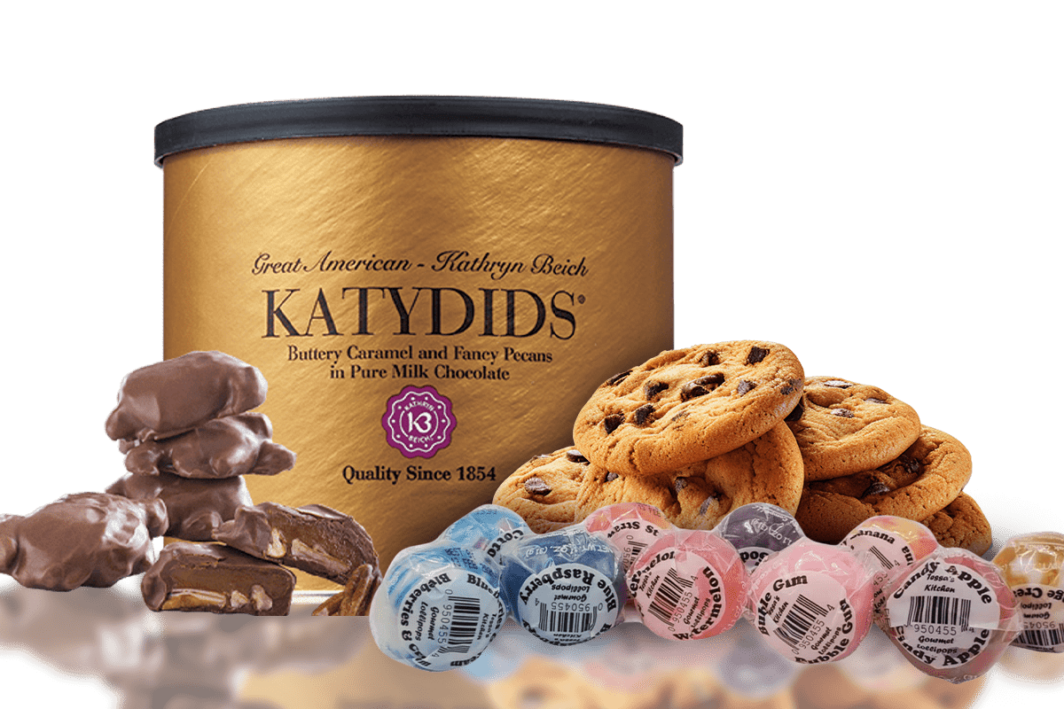 Katydids chocolate tin surrounded by chocolate chip cookies and assorted candy flavors.