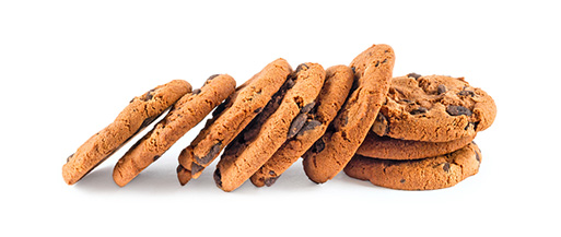 Stack of fresh chocolate chip cookies on a white background.