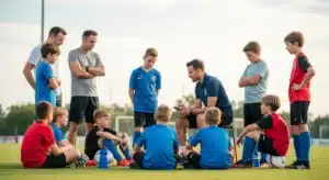 Youth soccer team discussing fundraising plan with coach on field